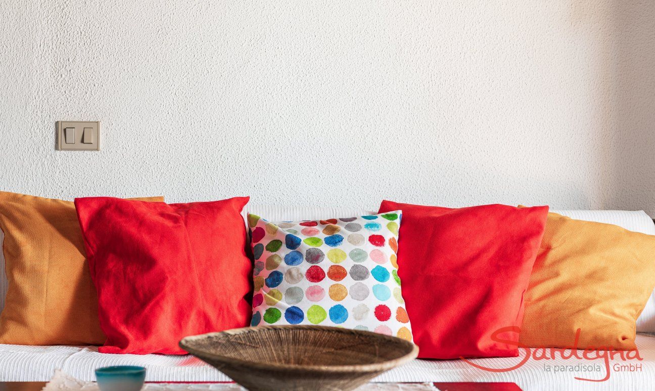 Apartment Nido 2 | Comfortabel couch with coloured cushions Nido 2, Costa Rei, South Sardinia