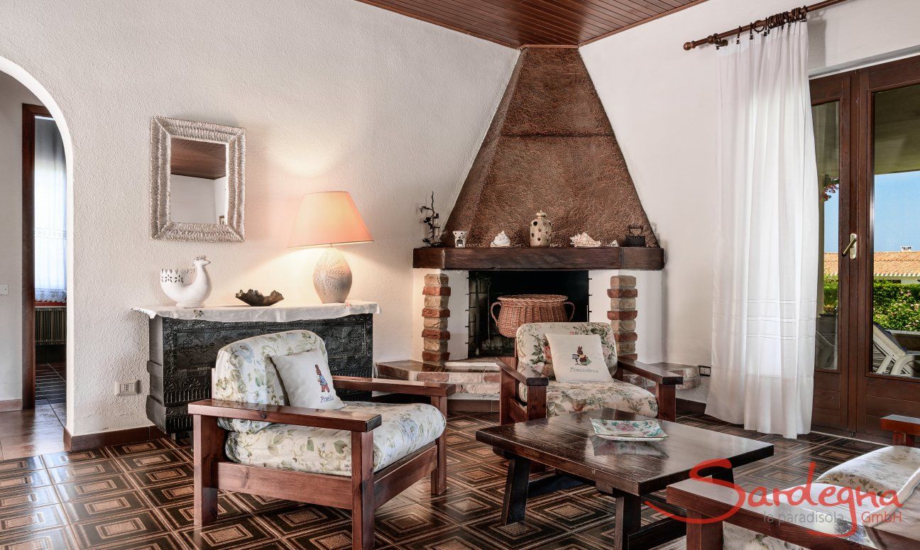 Villa Palme | Living room with big fire place and door to the terrace Living room with big fire place, Villa Palme, Costa Rei