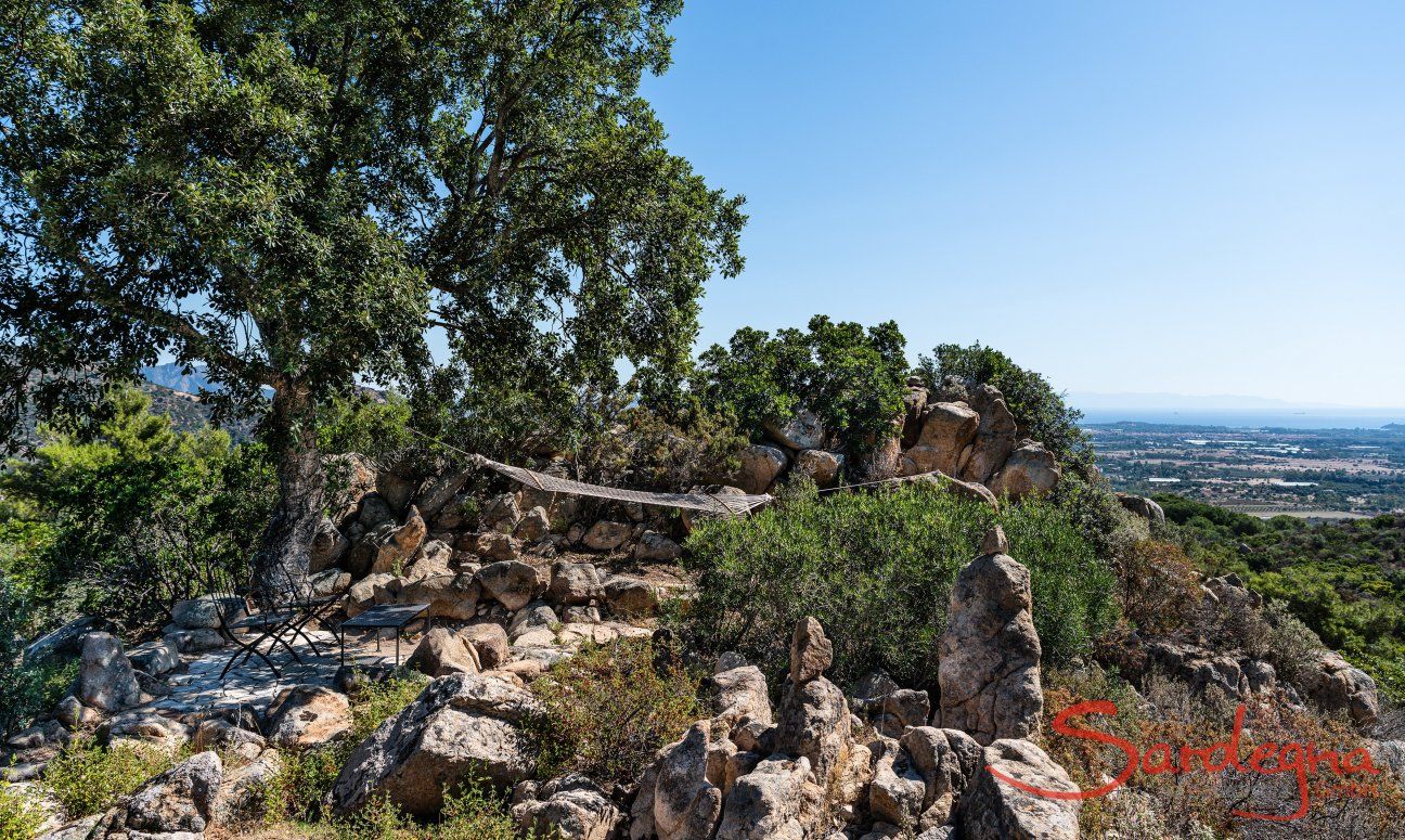 Villa Su Tauloni | Table and hammock in the shade of on old cork tree Villa Su Tauloni, Is Molas, South Sardinia