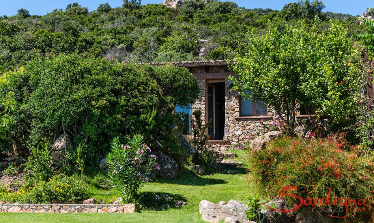 Villa Su Tauloni | Door from the green garden to one of the bedrooms Villa Su Tauloni, Is Molas, South Sardinia