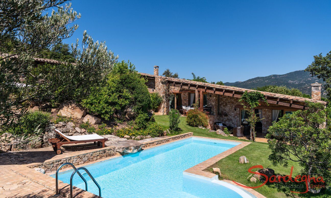 Villa Su Tauloni | Big pool in the green garden in front of the house Villa Su Tauloni, Is Molas, South Sardinia