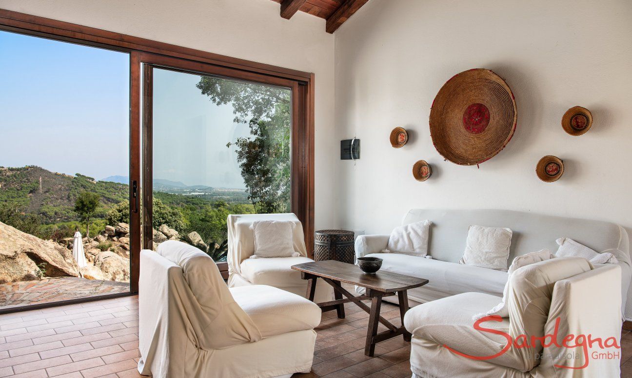Villa Fiorita | Comfotable seating area in the living room with view over the pool and valley Portrait of the villa