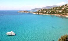 Bay of Torre delle Stelle, on the crystal clear sea hovers a small yacht