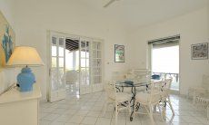Villa Bella | Dining area with panoramic windows and sea view Dining area with doors to the terrace