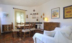 Casa Meloni 1 | Table in the living room with sofa and fire place Dining area