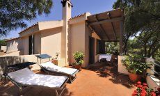 App. Pino | Terrace with blooming flowers, sun loungers and dining table App. Pino Terrace
