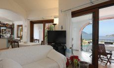 Villa Cala Ginepro | Living area with view on the isle of Tavolara Sardinia