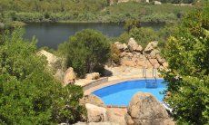 Villa Is Molas Monte | View from the garden onto the refershing blue water of the private pool and the green nature Pool