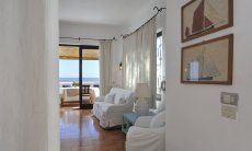 Villa Su Faru 1 | View of the living room, the terrace and the sea View of the living room of the terrace and of the sea