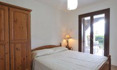 Apartment Castededdu 8 | Bedroom 2 with double sized bed and terrace access Bedroom 2 with double sized bed and terrace access