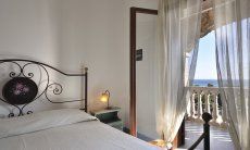 Apartment Castededdu 7 | Bedroom 1 with double sized bed and terrace access Bedroom 1 with double sized bed and terrace access