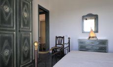 Apartment Castededdu 6 | Bedroom 1 with double sized bed and storage space Sardinia