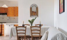 Apartment Castededdu 6 | Dining table, sofa corner and a view towards the kitchen Dining table, sofa corner and a view towards the kitchen
