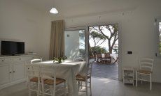 Apartment Cala Liberotto I | Dining table inside and outside Dining table inside and outside