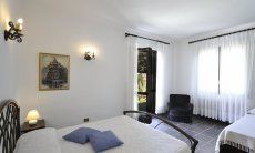 Villa Nautilus | Bedroom 2 with double sized bed, an extra bed and garden access Bedroom 2 with double sized bed, an extra bed and garden access