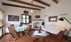 Living area with dining area and sofa next to the chimney