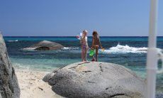 Children on the rocks in the sea of Sant Elmo