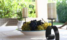 Villa Romana | Table docorated with fresh grapes and candles Sardinia
