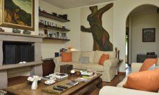 Villa Ulivi 12 | Living room with sofas, fireplace and garden view Living