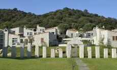 Holiday houses made out of grey granite rock form the complex Li Conchi