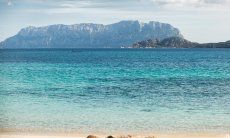 Water shimmering in turqoise blue colours in front of the isle of Tavolara close to Olbia