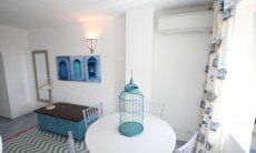 Li Conchi 25 | Table, chest and airconditioning in bedroom 3 Detail bedroom 3
