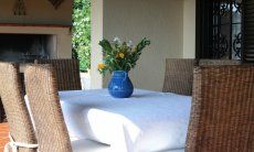 Villa Monica | Dining outside with the BBQ area in the back Dining outside with the BBQ area in the back