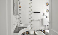 White tiled bathroom with shower