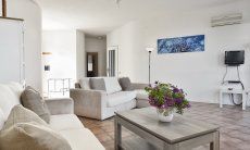 Villa Massidda | Spacious living room with natural light and access to the bedroom area Wide living room with natural light