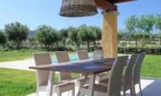 Villa Campidano 20 | Dining table outside with garden view Dining table on the roofed terrace of Villa Campidano 20