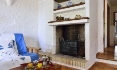 Villa Gaia | Fireplace close to the sofa corner Chimney at the sofa corner