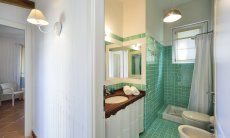 Li Conchi 9 | Second bathroom with shower and bidet Bath with shower and light green tiles, Li Conchi 9, Cala Sinzias