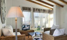 Li Conchi 9 | Living room with big panorama window Sofa corner in the living room of Li Conchi 9, Cala Sinzias