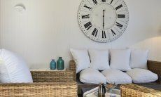 Li Conchi 10 | Cozy wicker sofa and large wall clock Sofa Li Conchi 10, Cala Sinzias