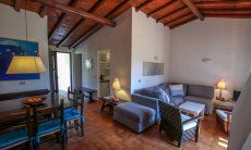 Villetta 12 | Living area with dining table and a sofa Living area with dining table and a sofa