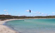 Beach of Lu Impostu with kite surfer