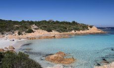 Crystal clear water over the white sandy sea bed of the beach Romazzino