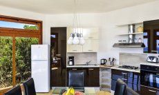 Villa Torretta Chia | Open kitchen and dining table Open kitchen and dining area inside