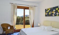 Villa Torretta Chia | Bedroom 1 with double sized bed and garden access and private bath Bedroom 1 with double sized bed and garden access