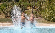 Two boys jump into the pool of Li Conchi