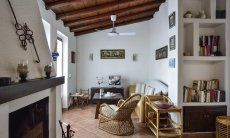 Villa Ibiscus | Living area with sofa corner, bookshelf and chimney Living area with sofa corner, bookshelf and chimney