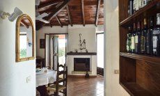Villa Ibiscus | Living room with dining table and a sardinian chimney Living room with dining table and a sardinian chimney