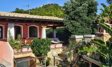 Villa Le Ginestre 2 | Covered terrace with sunbeds to relax View of the house and garden