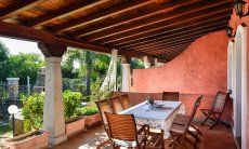 Villa Le Ginestre 2 | Roofed terrace with dining table Roofed terrace with dining table