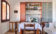 Villa Le Ginestre 2 | Living room upstairs with table, sofa and cupboard Living room upstairs with table, sofa and cupboard