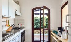 Villa Le Ginestre 2 | Kitchen upstairs with garden access Kitchen upstairs with garden access