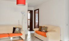 Villa Le Ginestre 2 | Living souterrain with a sofa corner Living souterrain with a sofa corner