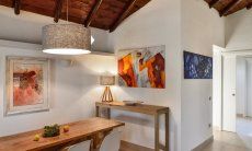 Villetta Quattro | Dining area with paintings on the wall Dining area with paintings on the wall