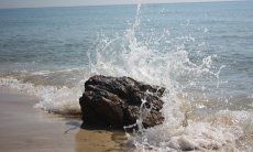 Villa Kika | Water crushing on a rock on the shore Water crushing on a rock on the shore