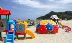 Playground for children on the beach of Cala Sinzias